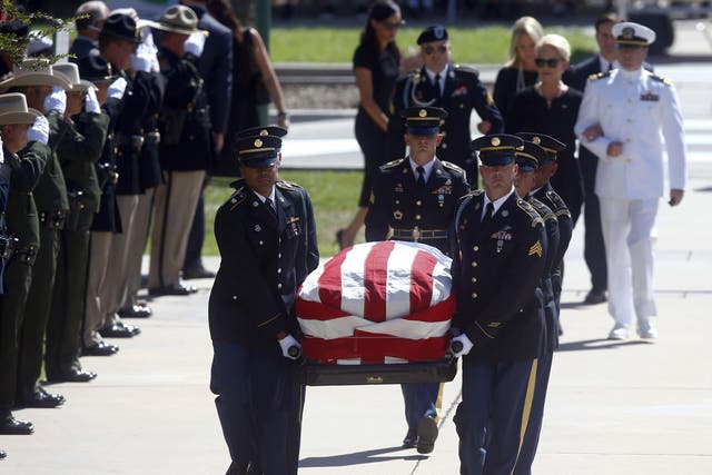 Cindy McCain, wife of Sen. John McCain, R-Ariz. follows the casket, carried by members of the Arizona National Guard, with her sons Jack, right, and Jimmy for a memorial service at the Arizona Capitol