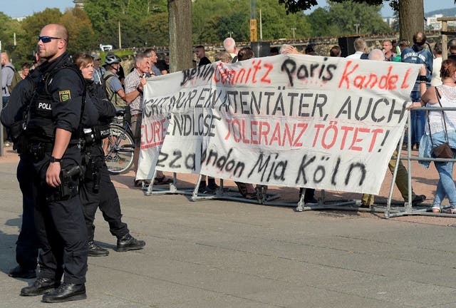 Police officers guard right wing demonstrators during a far-right demonstration in Dresden, Germany, on Tuesday 28 August.