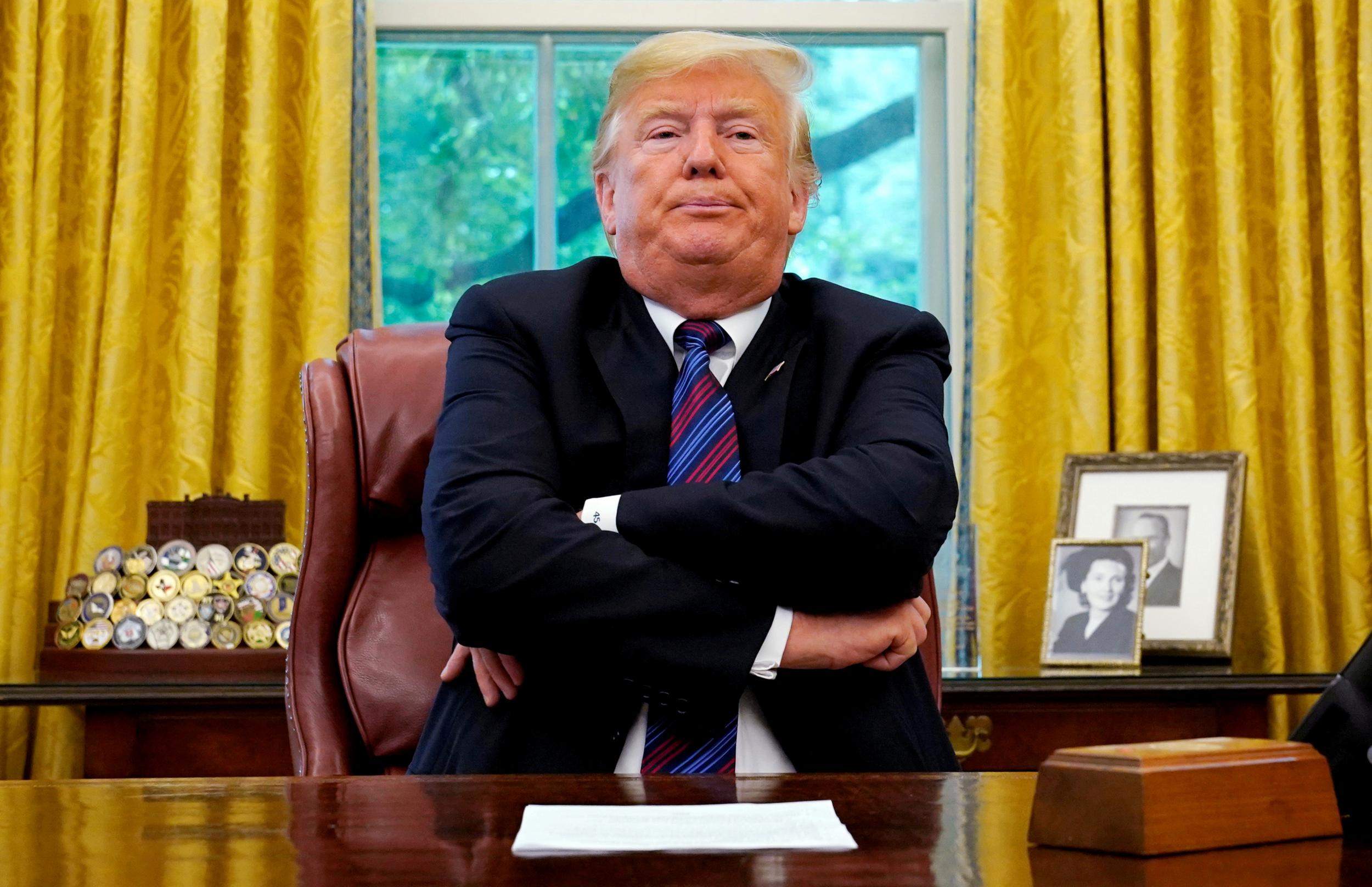 President Donald Trump sits behind his desk as he announces a bilateral trade agreement with Mexico to replace the North American Free Trade Agreement (NAFTA) at the White House in Washington, 27 August 2018