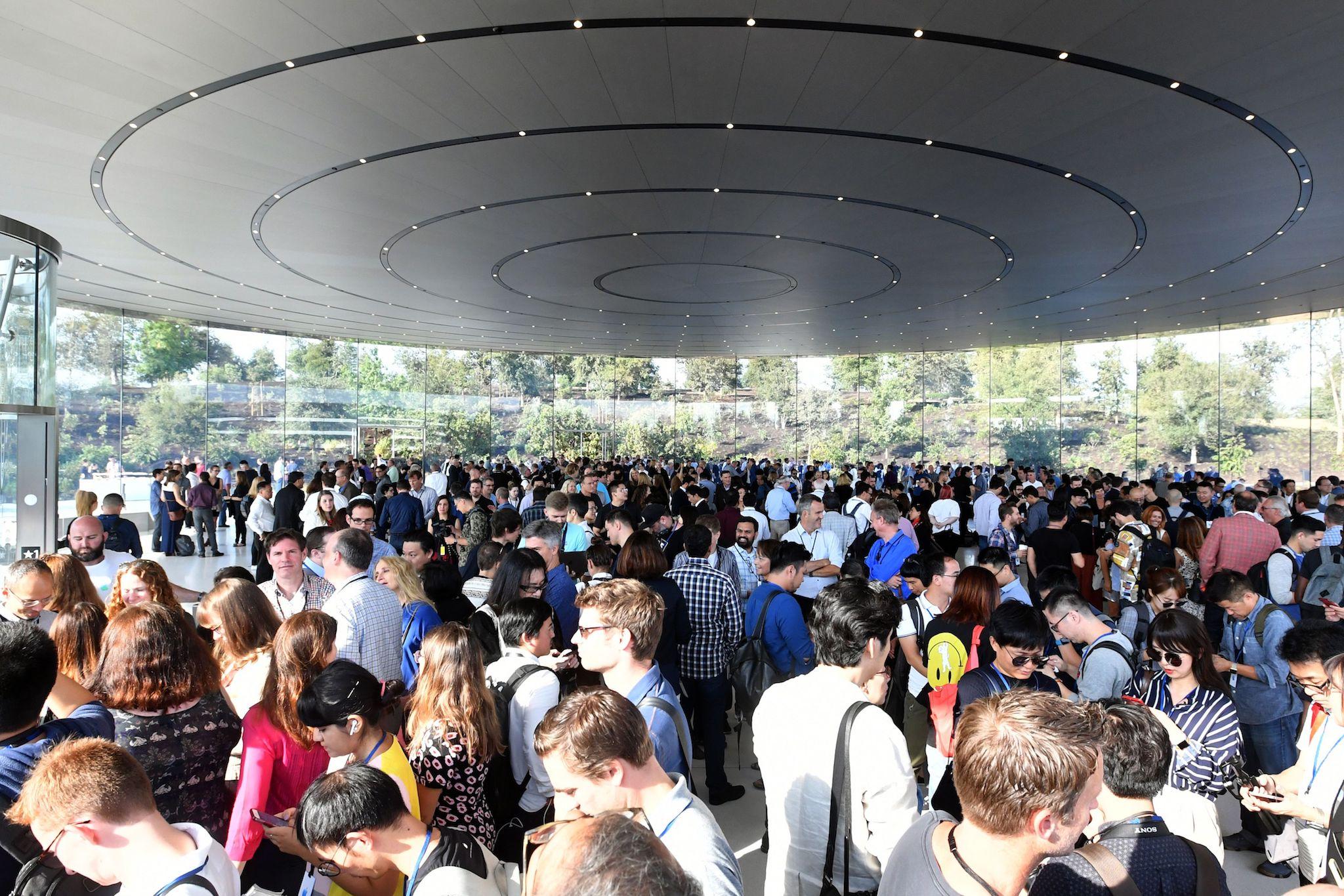 A crowd of people wait to enter the Steve Jobs Theater ahead of a media event