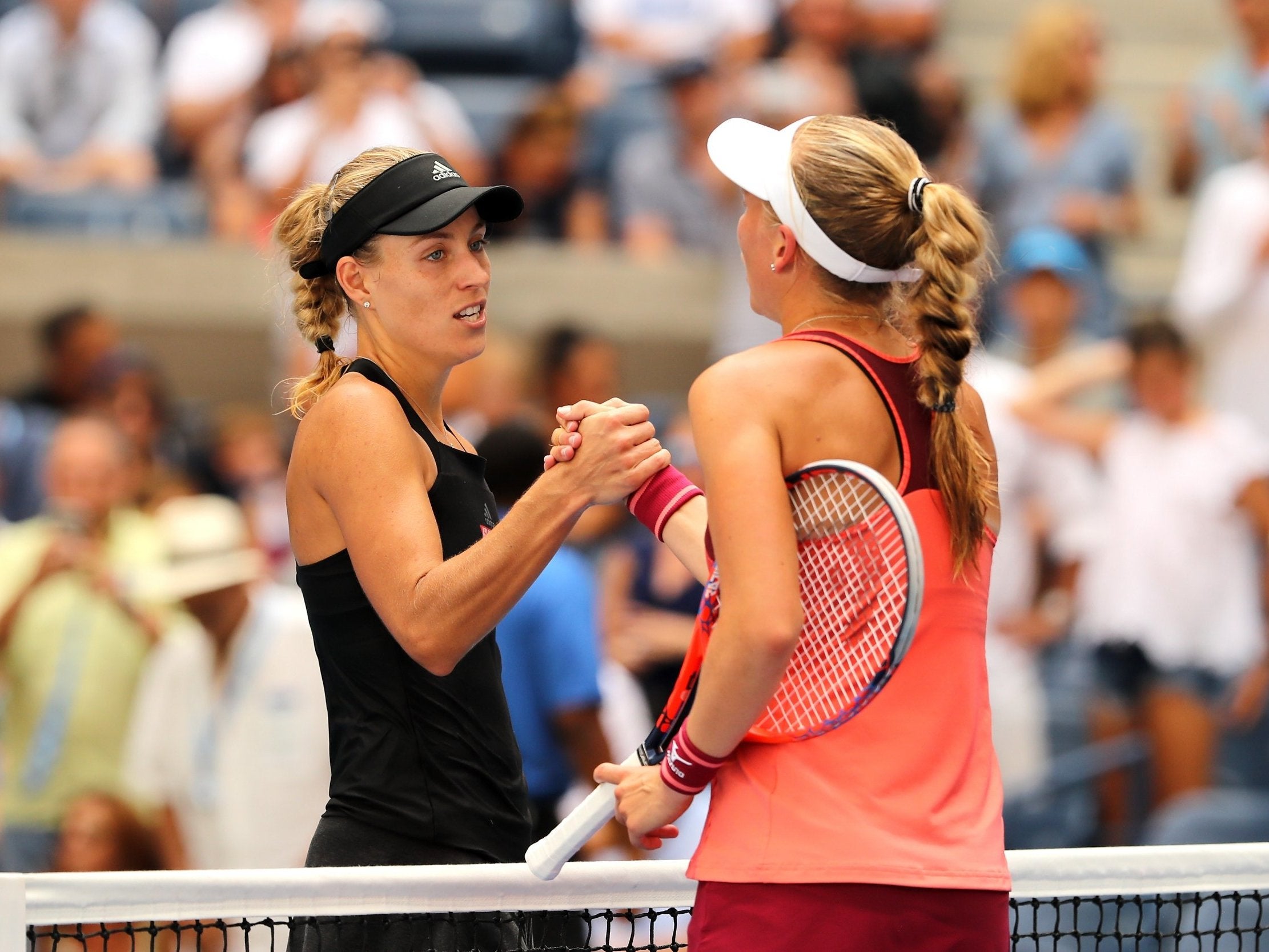 Angelique Kerber shakes hands with Johanna Larsson at the net
