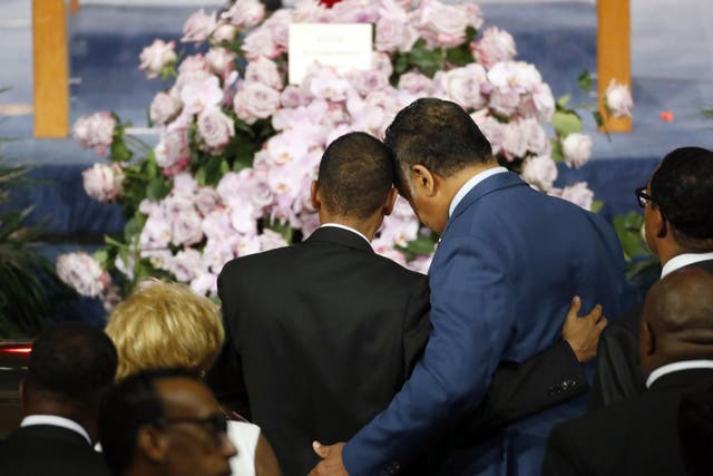Reverend Jesse Jackson consoles a family member as they pause at the casket of Aretha Franklin during her funeral service at Greater Grace Temple