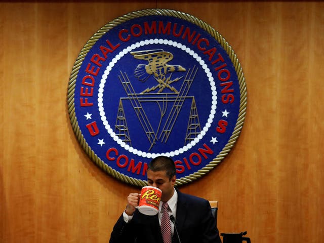 Chairman Ajit Paid drinks coffee ahead of the vote on the repeal of so called net neutrality rules at the Federal Communications Commission
