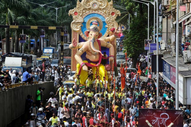 Devotees carry an idol of the Hindu god Ganesh in Mumbai, India