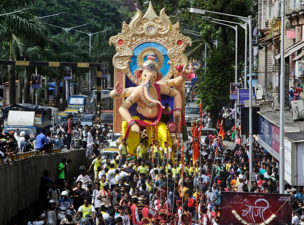 Devotees carry an idol of the Hindu god Ganesh in Mumbai, India