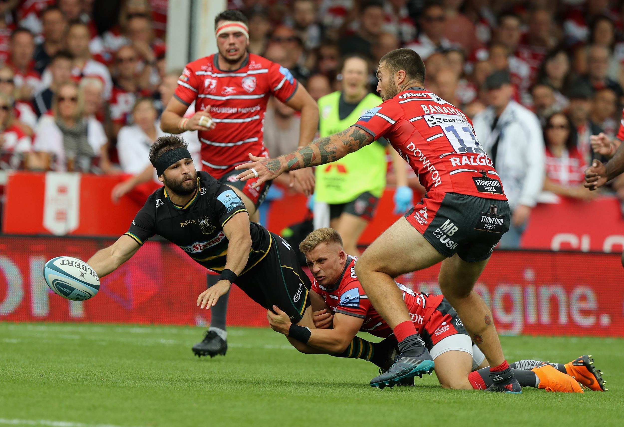 Cobus Reinach attempts an offload as Northampton attack