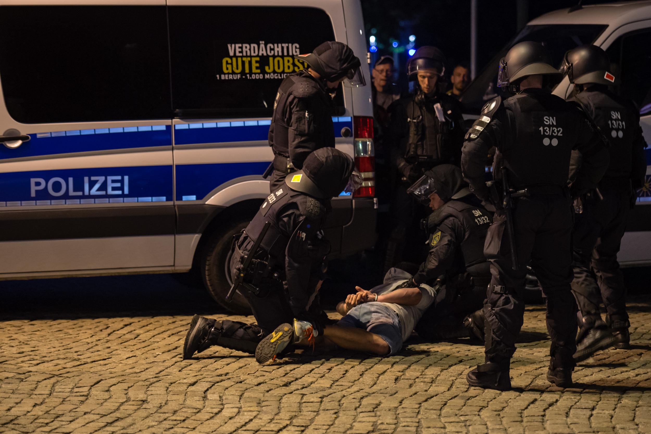 Riot police arrest a man on the verge of a right-wing march after the police closed the march following a blockade of counter-demonstrators on 1 September 2018 in Chemnitz.