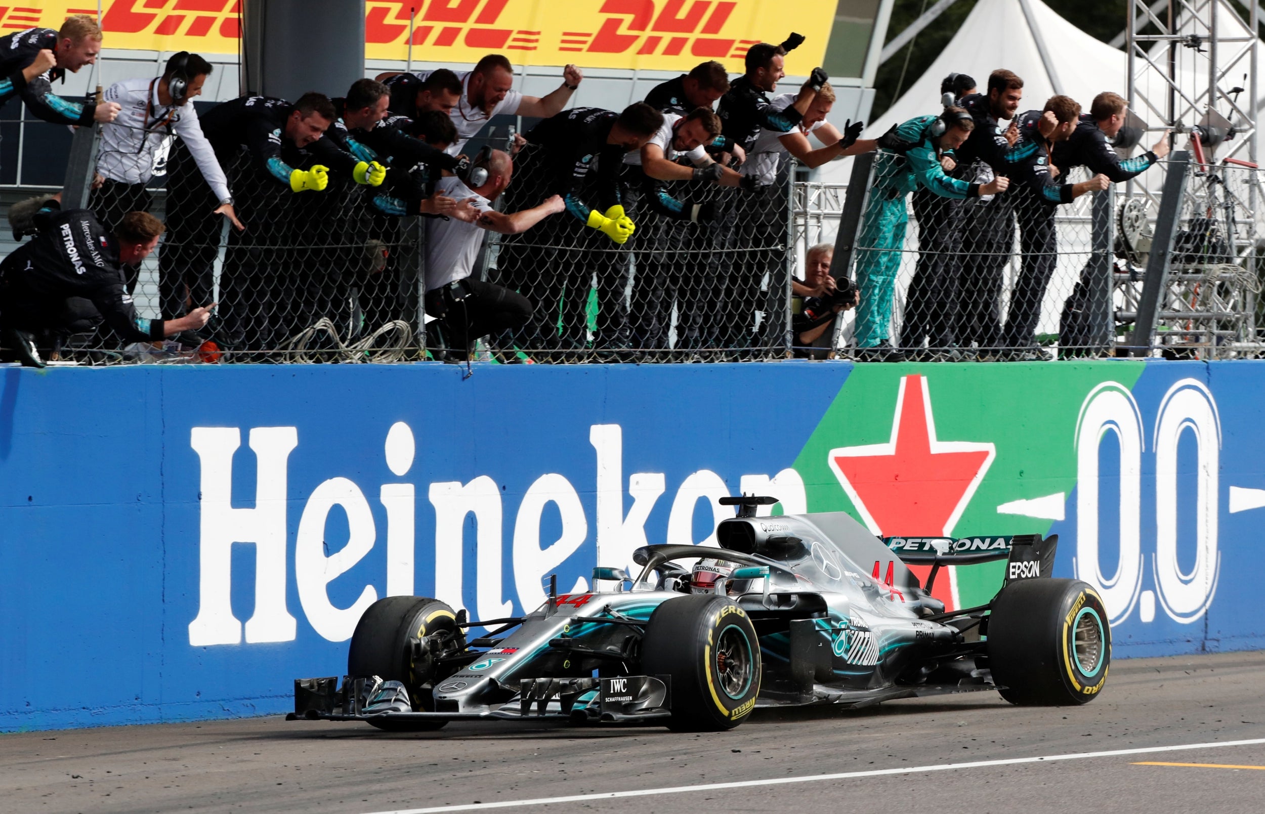 Hamilton is cheered home by his Mercedes team (Reuters)