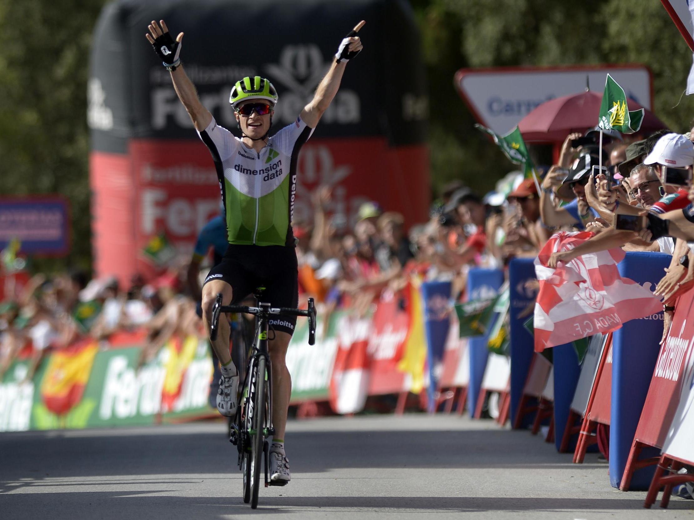 Ben King celebrates his stage nine win as he crosses the finishing line
