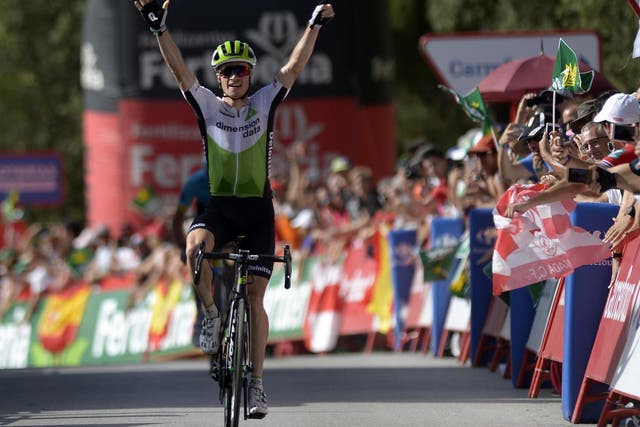 Ben King celebrates his stage nine win as he crosses the finishing line