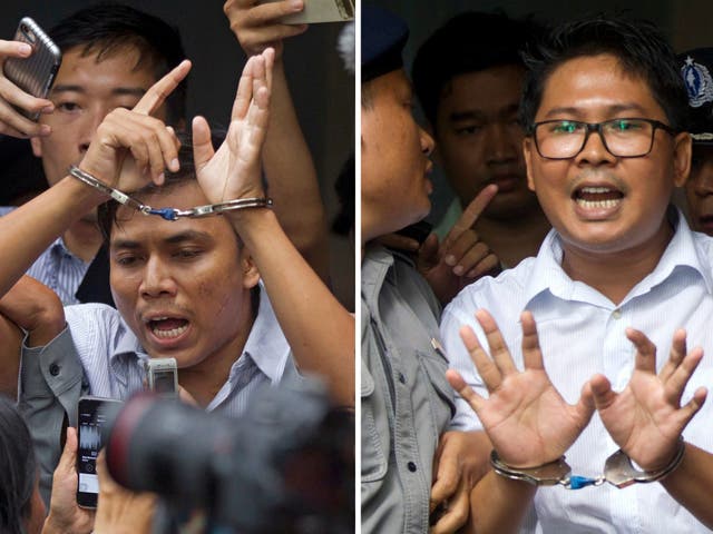 Kyaw Soe Oo, left, and  Wa Lone, are handcuffed as they are escorted by police out of court after being sentenced on Monday, 3 September