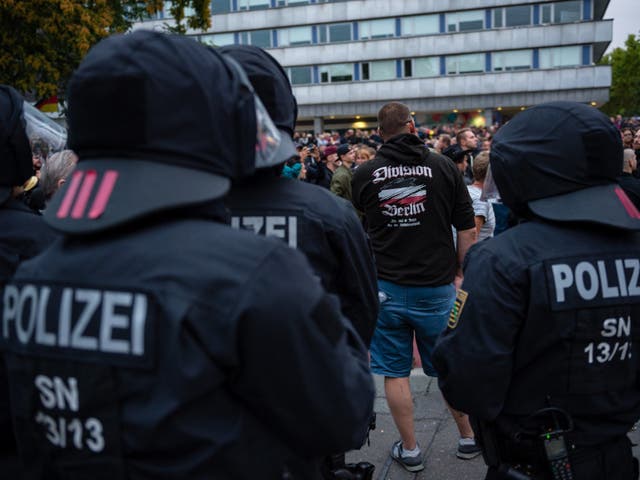 Riot police observe a far-right march in Chemnitz, Germany