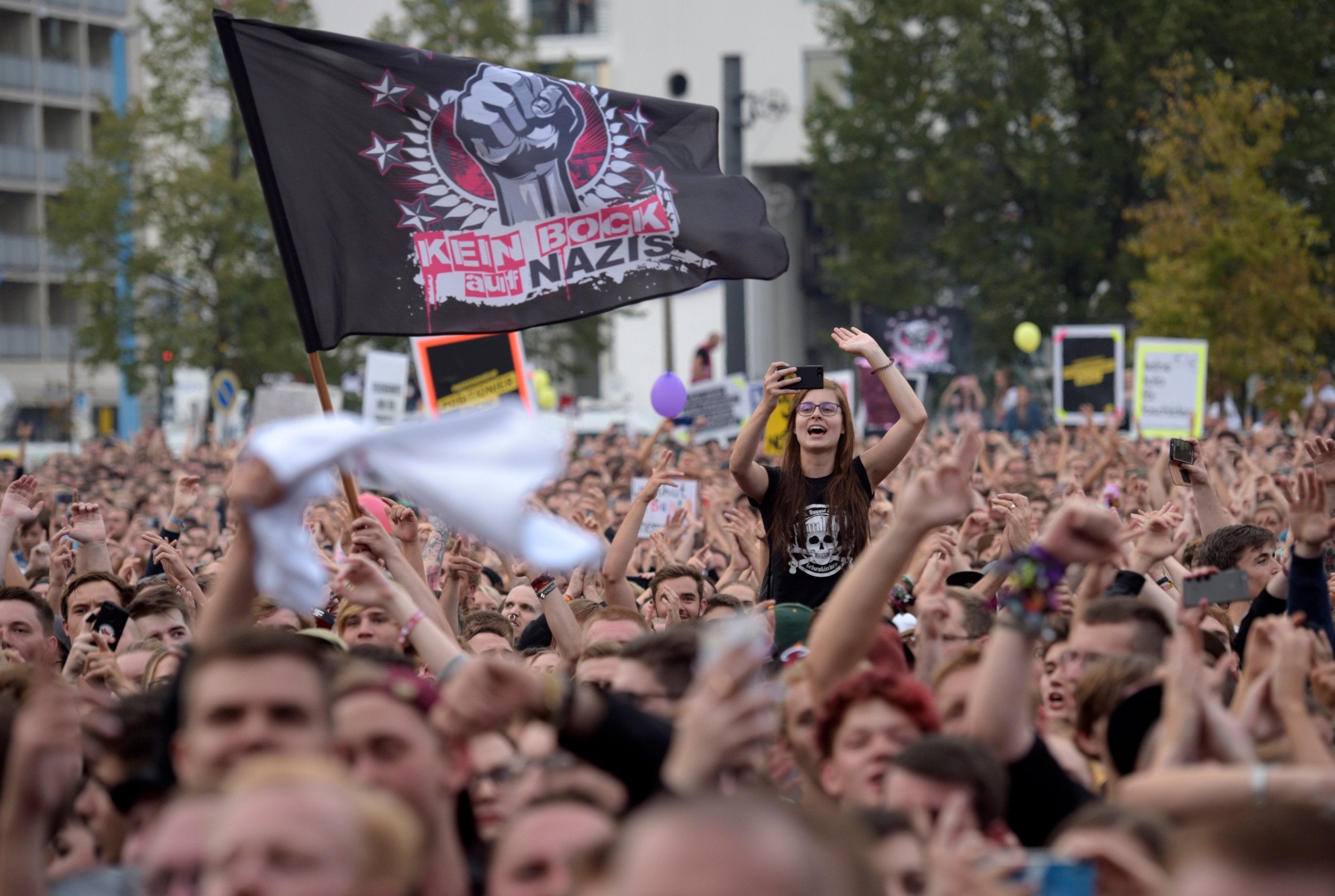 An anti-Nazi flag flies among crowds in Chemnitz
