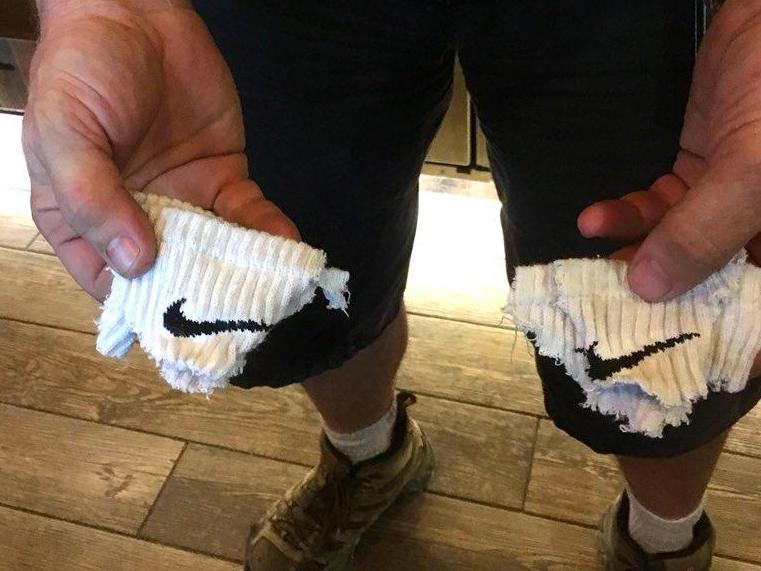 cutting Nike logo off socks in protest 