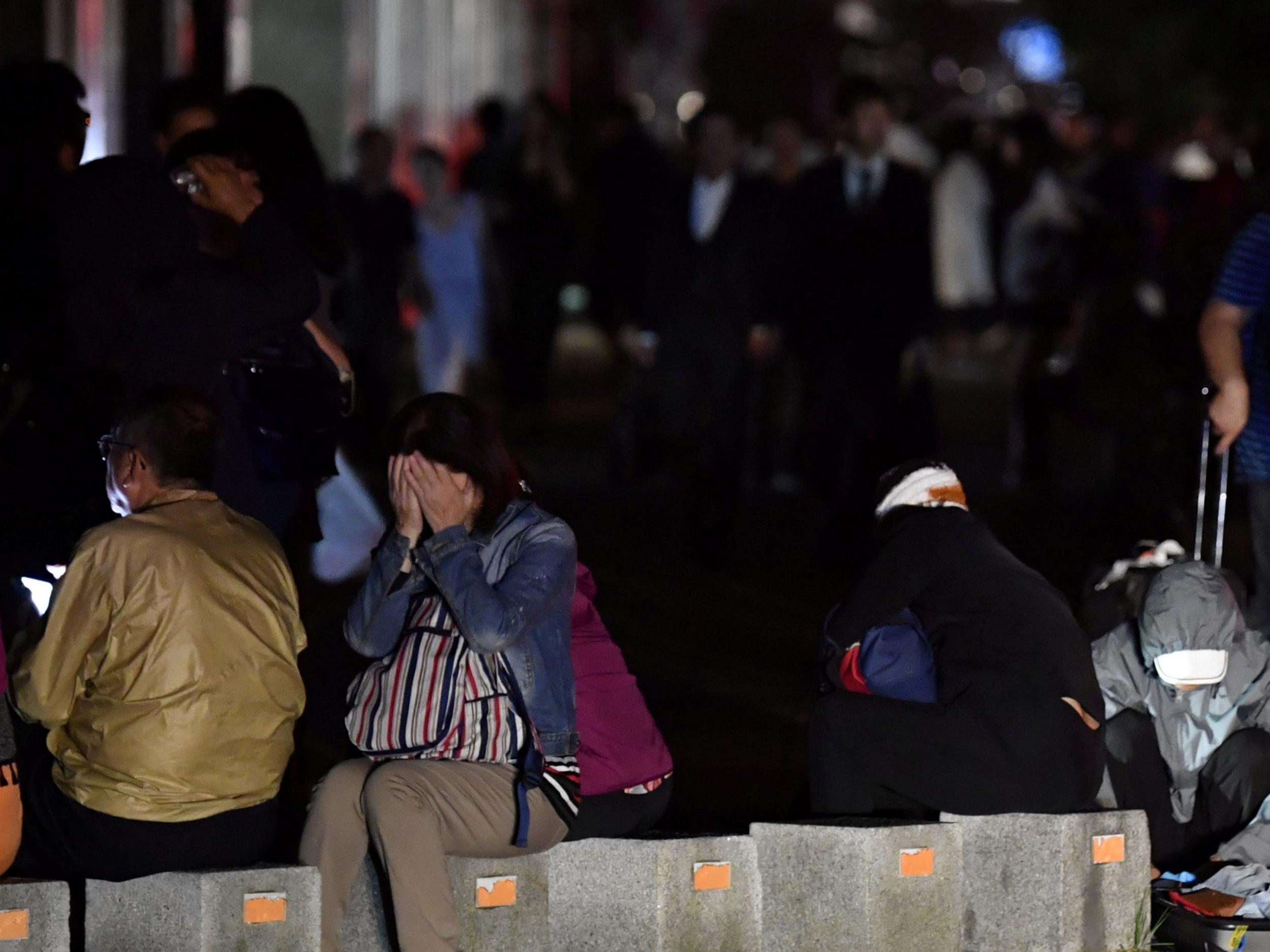 People react during blackout after a powerful earthquake hit the area in Sapporo, Japan