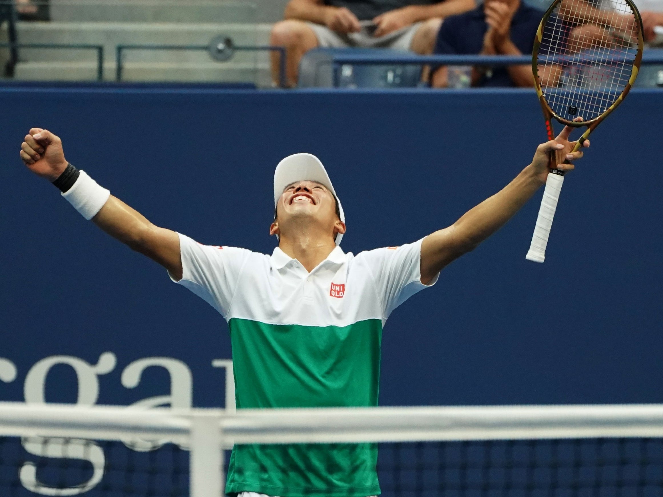 Kei Nishikori celebrates after defeating Marin Cilic