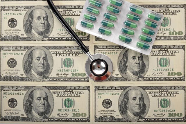 Pills, stethoscope, dollar banknotes, symbolic picture for the explosion of healthcare costs, medical expenses, recovery of the dollar