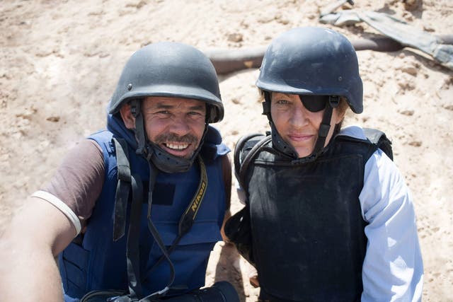 War photographer Paul Conroy, pictured here with Marie Colvin, has said he hopes a new documentary, Under the Wire, which captures the death of journalist Colvin, injects a sense of shame into the Syrian regime