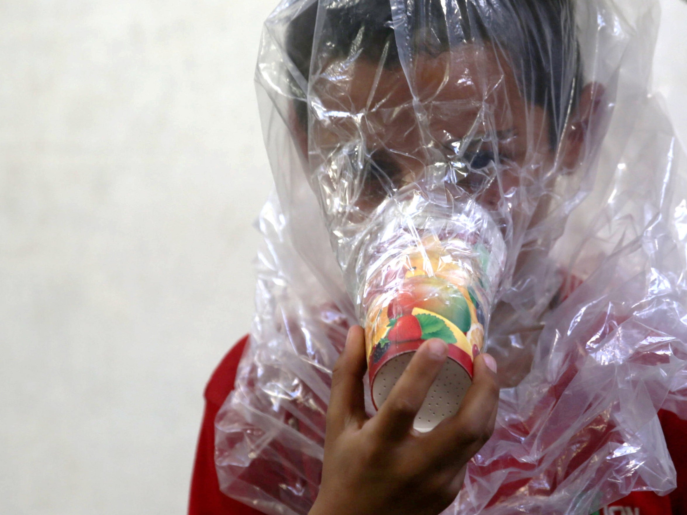 A child wears a homemade gas mask (Reuters)