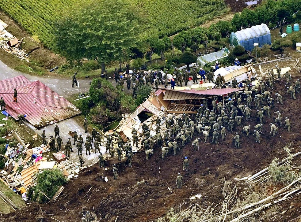 Members of the Japan Self-Defence Forces search for landslide survivors on Friday