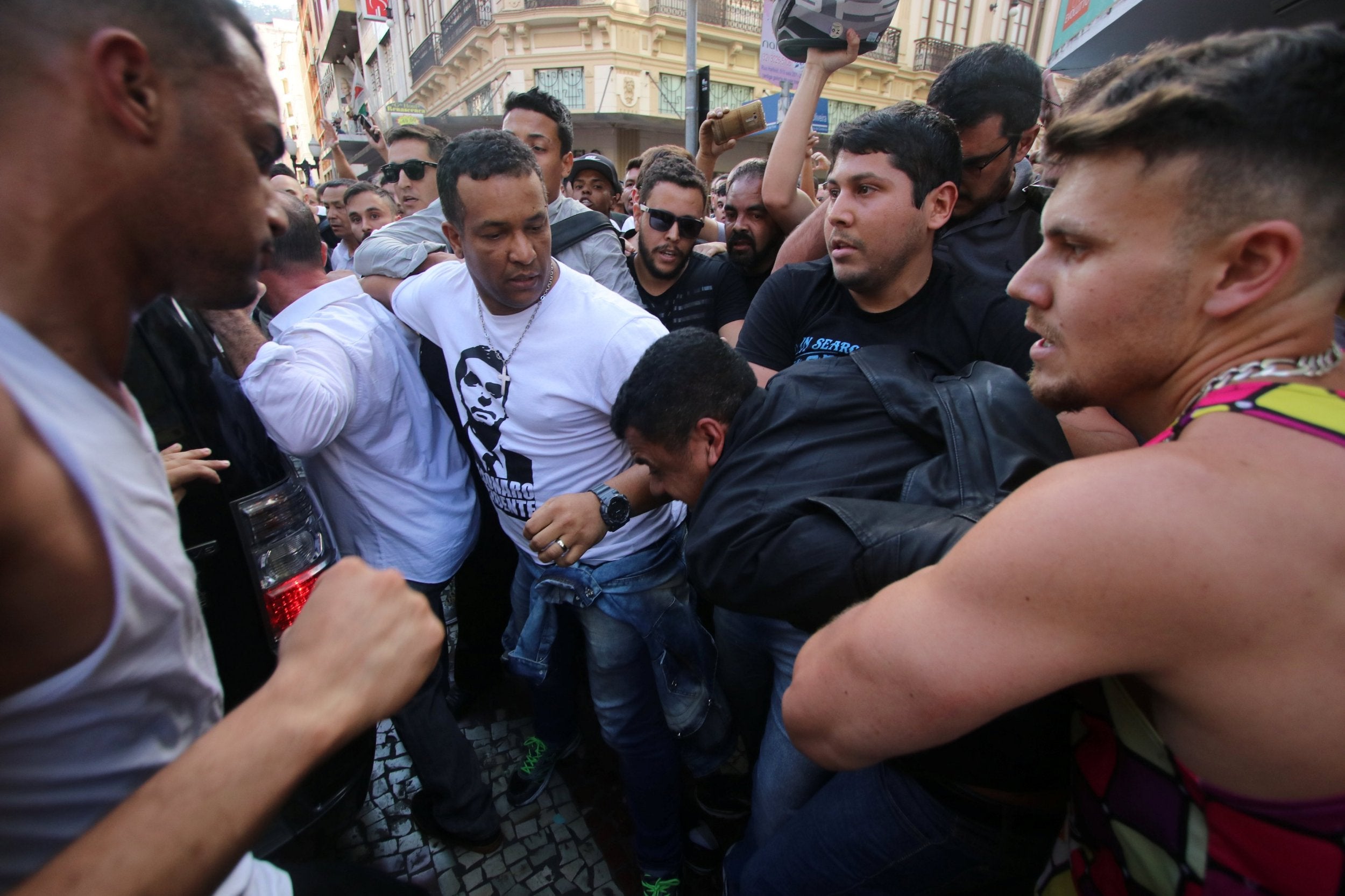 Jair Bolsonaro supporters surround a man suspected of stabbing the far-right candidate