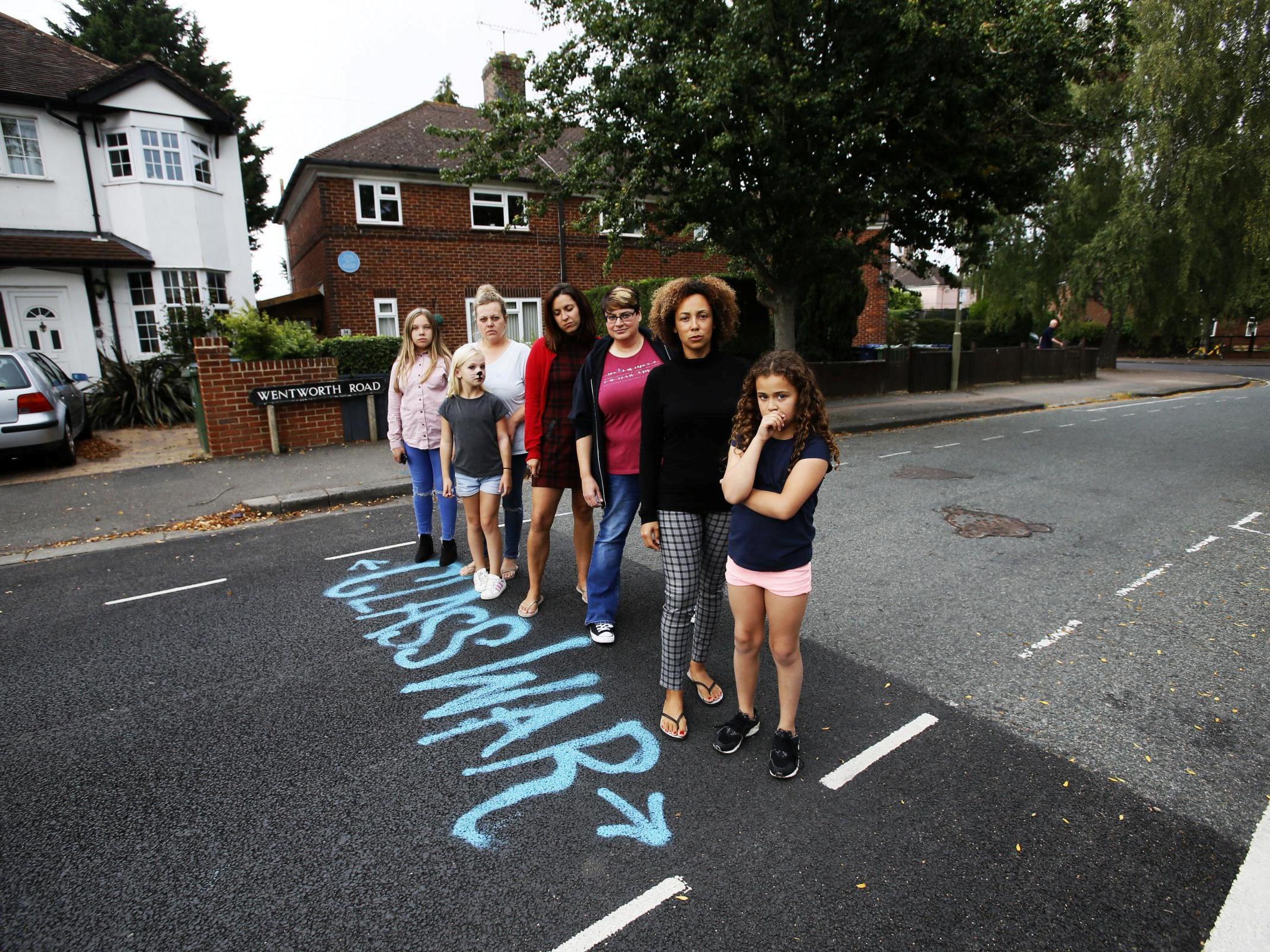 Residents mark the point where resurfacing stops