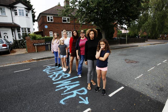 Residents mark the point where resurfacing stops