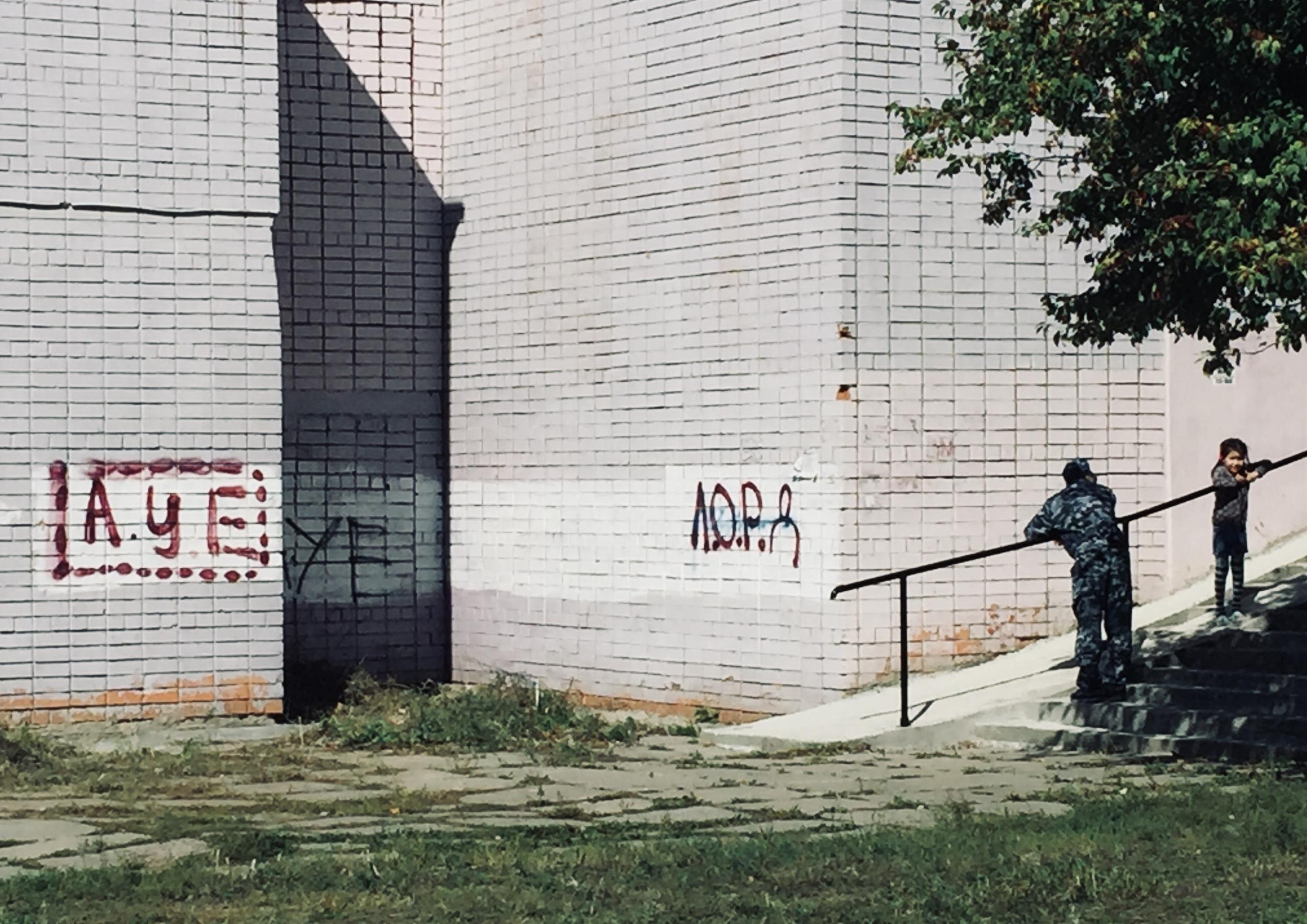 In outskirts of Irkutsk, graffiti praising “AUE“ – a gang-type movement pushing youngsters into the underground. Serious crime has fallen significantly since the 1990s, which were especially dark times in Irkutsk and surrounding towns. But locals complain some of the criminals have since moved into ruling party politics.