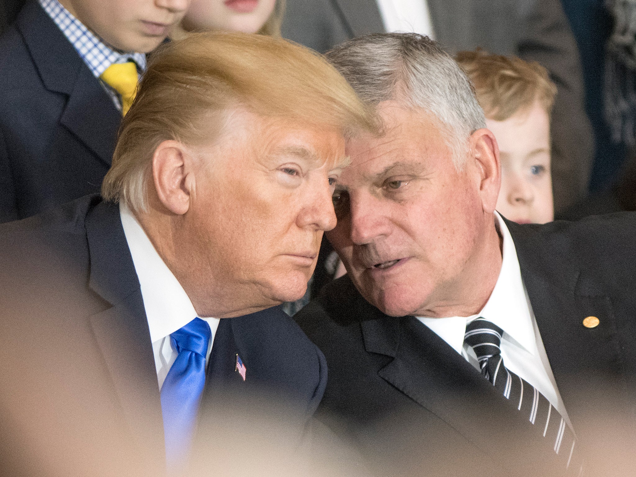 Franklin Graham (R) talks with Donald Trump in February 2018