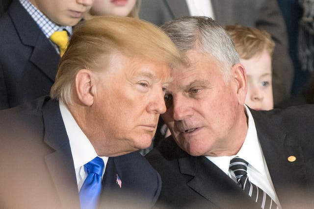 Franklin Graham (R) talks with Donald Trump in February 2018