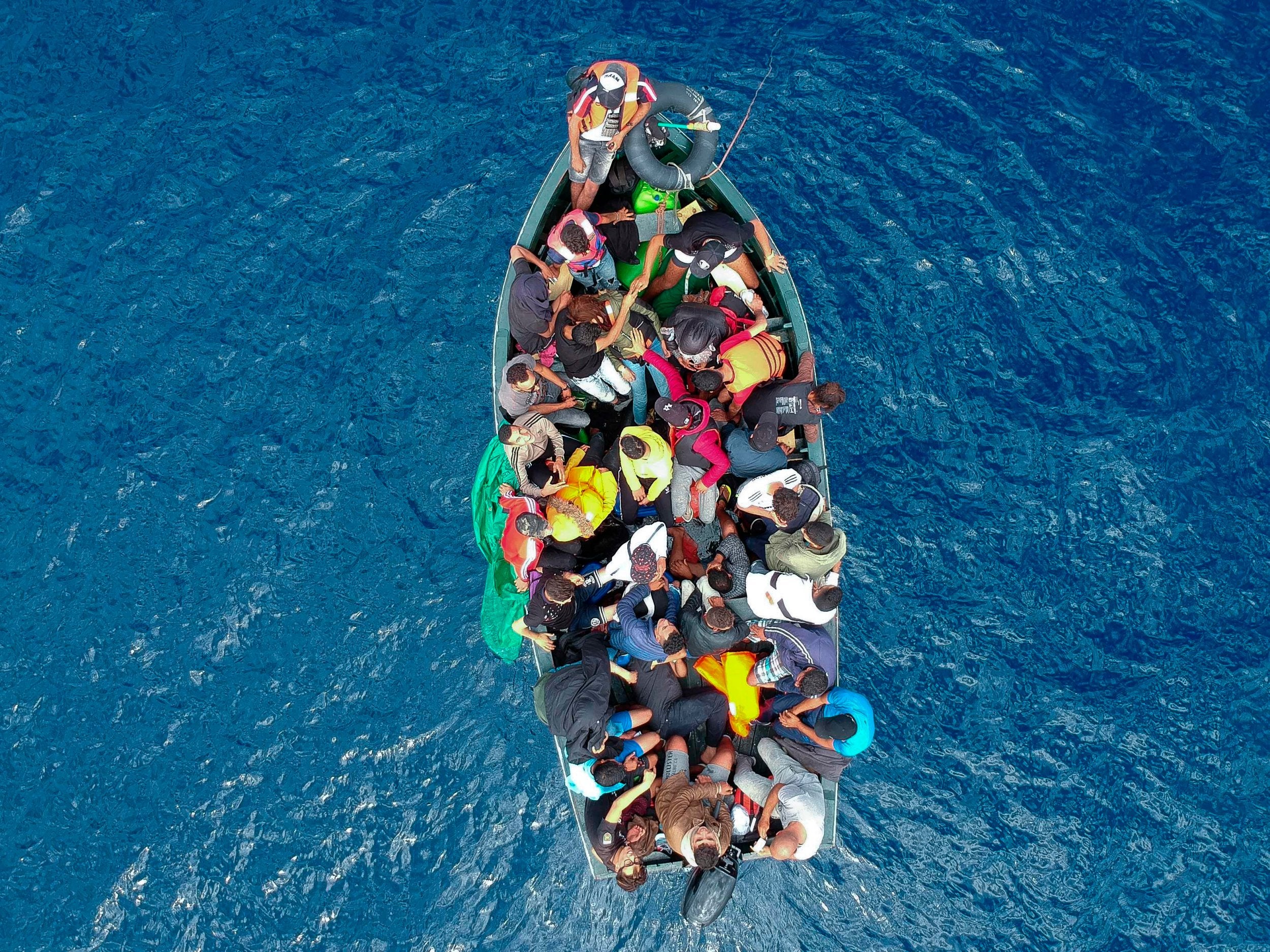 Theresa May announces crackdown on people smugglers advertising services on Facebook