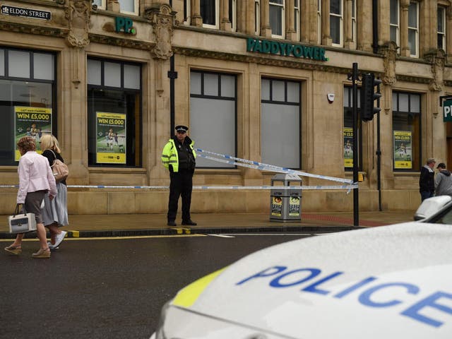 A police officer stands on duty by a police cordon on Eldon Street, following a stabbing incident in the centre of Barnsley
