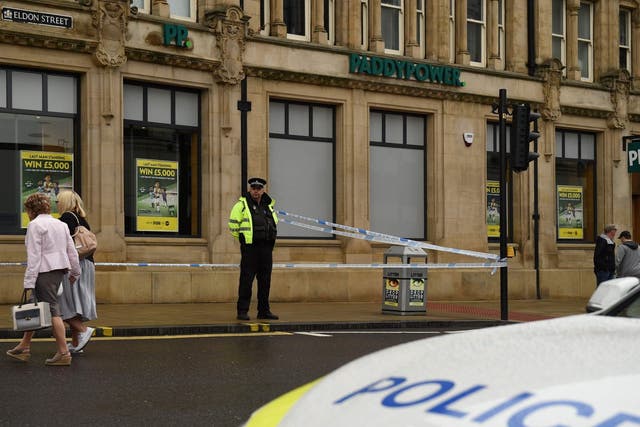 A police officer stands on duty by a police cordon on Eldon Street, following a stabbing incident in the centre of Barnsley