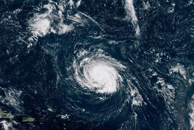 Hurricane Florence seen over the Atlantic Ocean, about 750 miles southeast of Bermuda in this handout photo provided by the National Oceanic and Atmospheric Administration