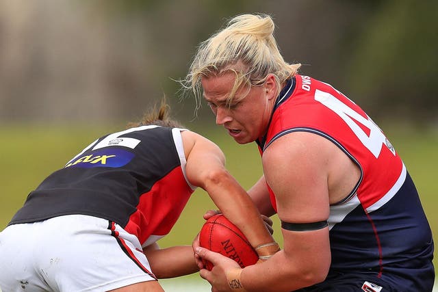 Hannah Mouncey (right) has withdrawn from the 2019 AFLW Draft and accused officials of blocking her from playing