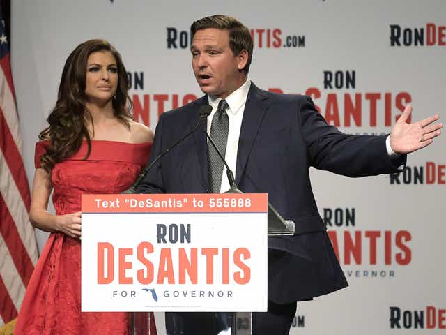 Florida Republican gubernatorial candidate Ron DeSantis, right, speaks to supporters with his wife, Casey, at an election party after winning the Republican primary