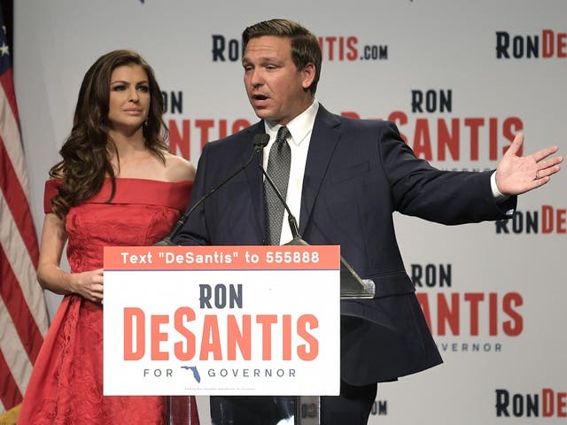 Florida Republican gubernatorial candidate Ron DeSantis, right, speaks to supporters with his wife, Casey, at an election party after winning the Republican primary