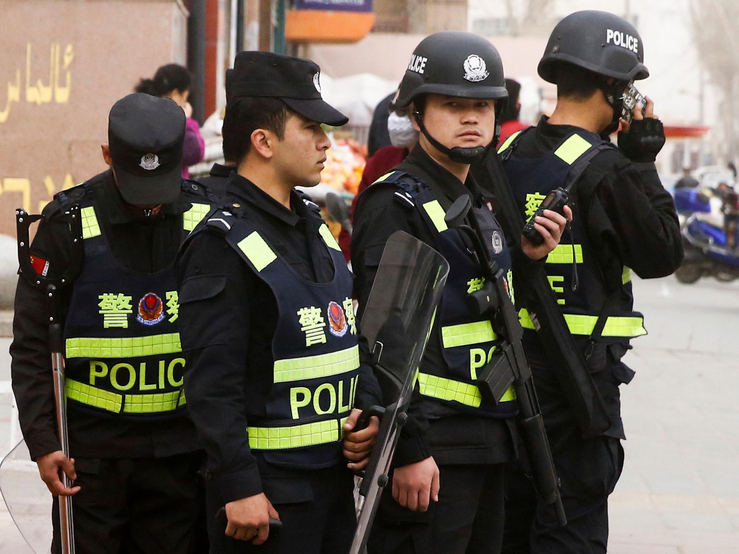 Armed police keep watch in a street in Kashgar, Xinjiang Uighur Autonomous Region, China