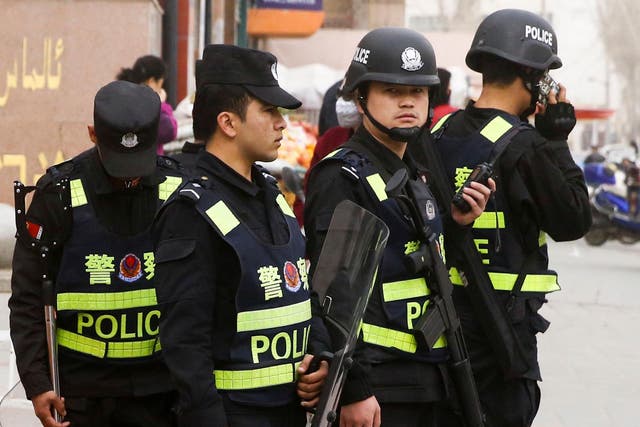 Armed police keep watch in a street in Kashgar, Xinjiang Uighur Autonomous Region, China