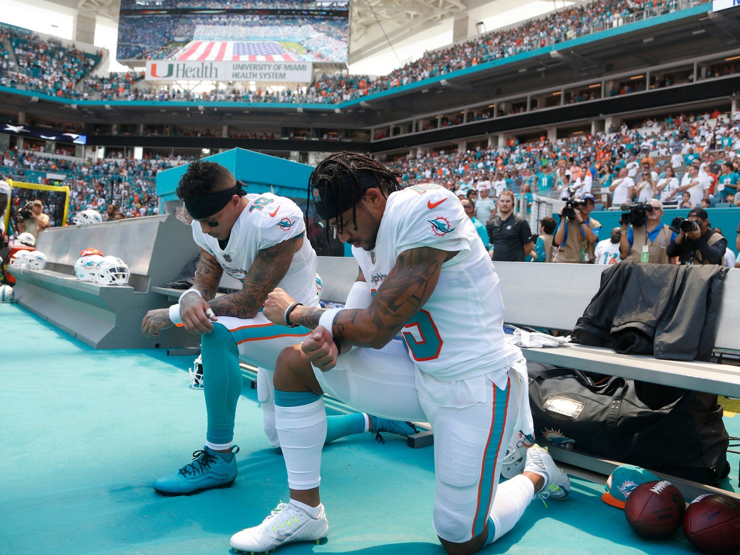 Kenny Stills and Albert Wilson protest during the national anthem