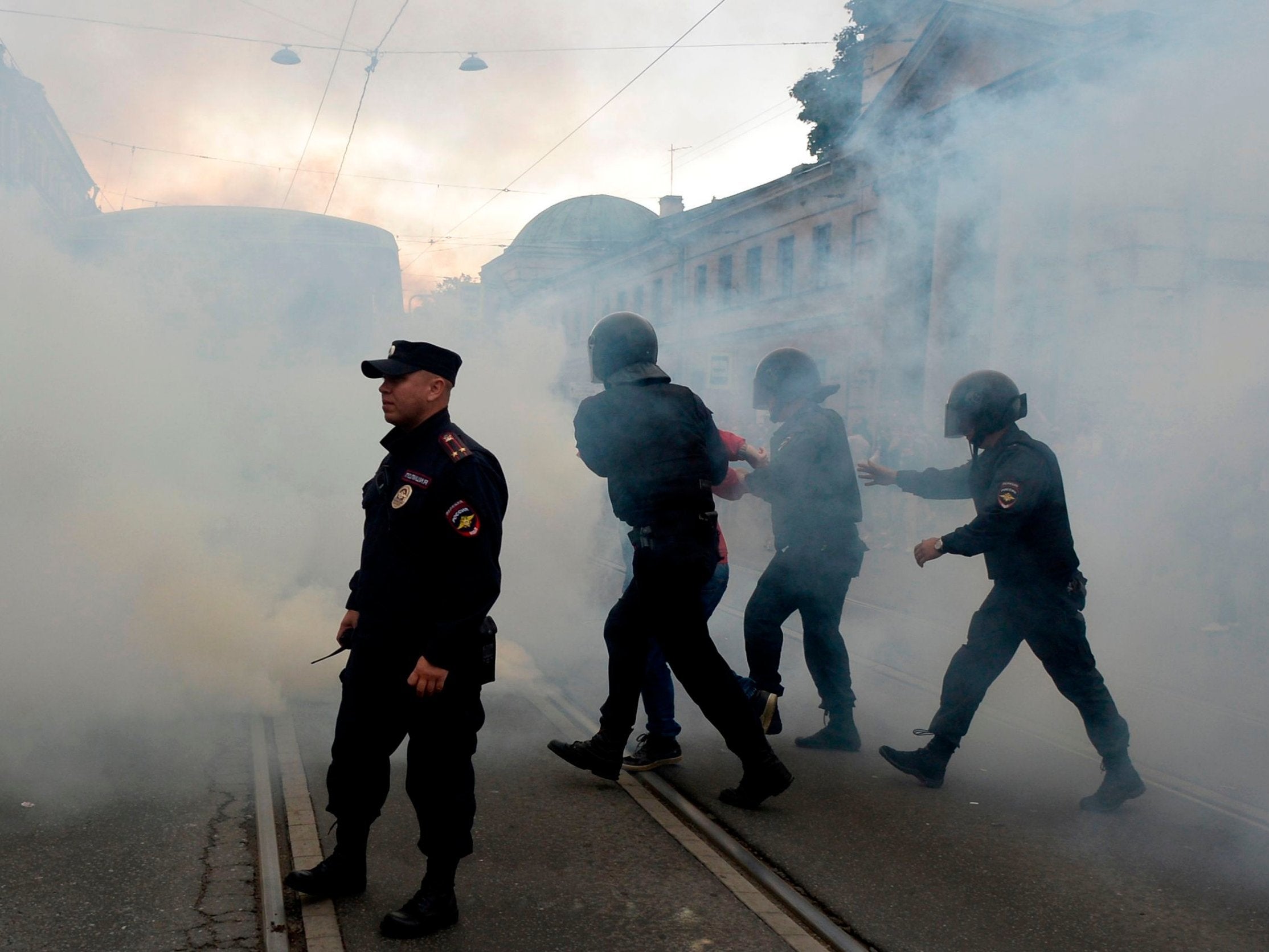 Police officers detain protesters during a demonstration in St Petersburg