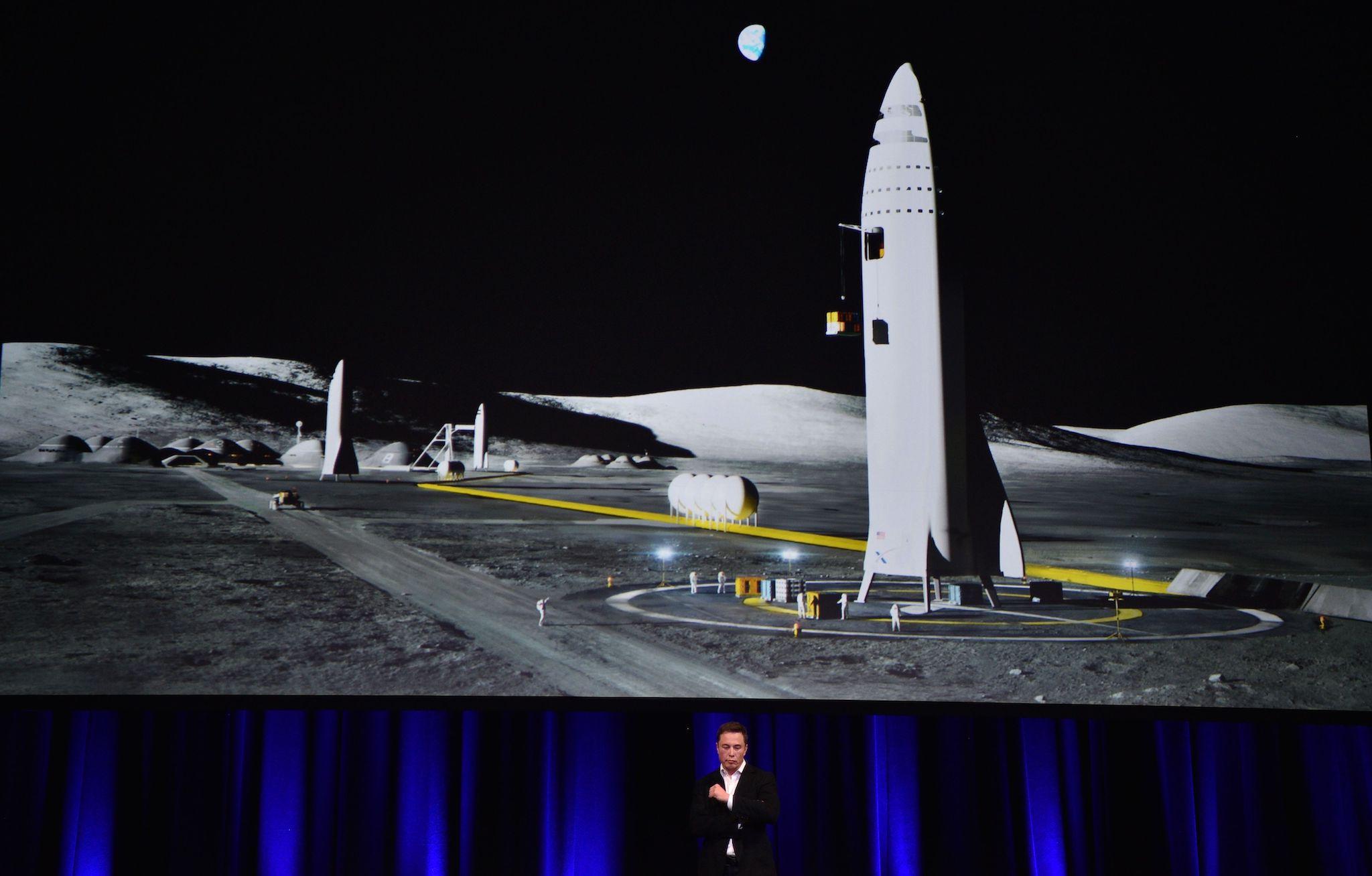 Billionaire entrepreneur and founder of SpaceX Elon Musk speaks below a computer generated illustration of his new rocket at the 68th International Astronautical Congress 2017 in Adelaide on September 29, 2017
