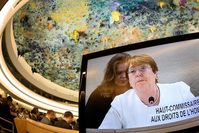 New High Commissioner for Human Rights Michelle Bachelet is seen on a TV screen delivering her speech during theh UN Council of Human Rights meeting in Geneva on 10 September 2018.
