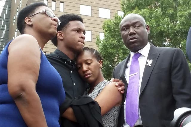 Brandt Jean, center left, brother of shooting victim Botham Jean, hugs his sister Allisa Charles-Findley, during a news conference outside the Frank Crowley Courts Building on September 10, 2018