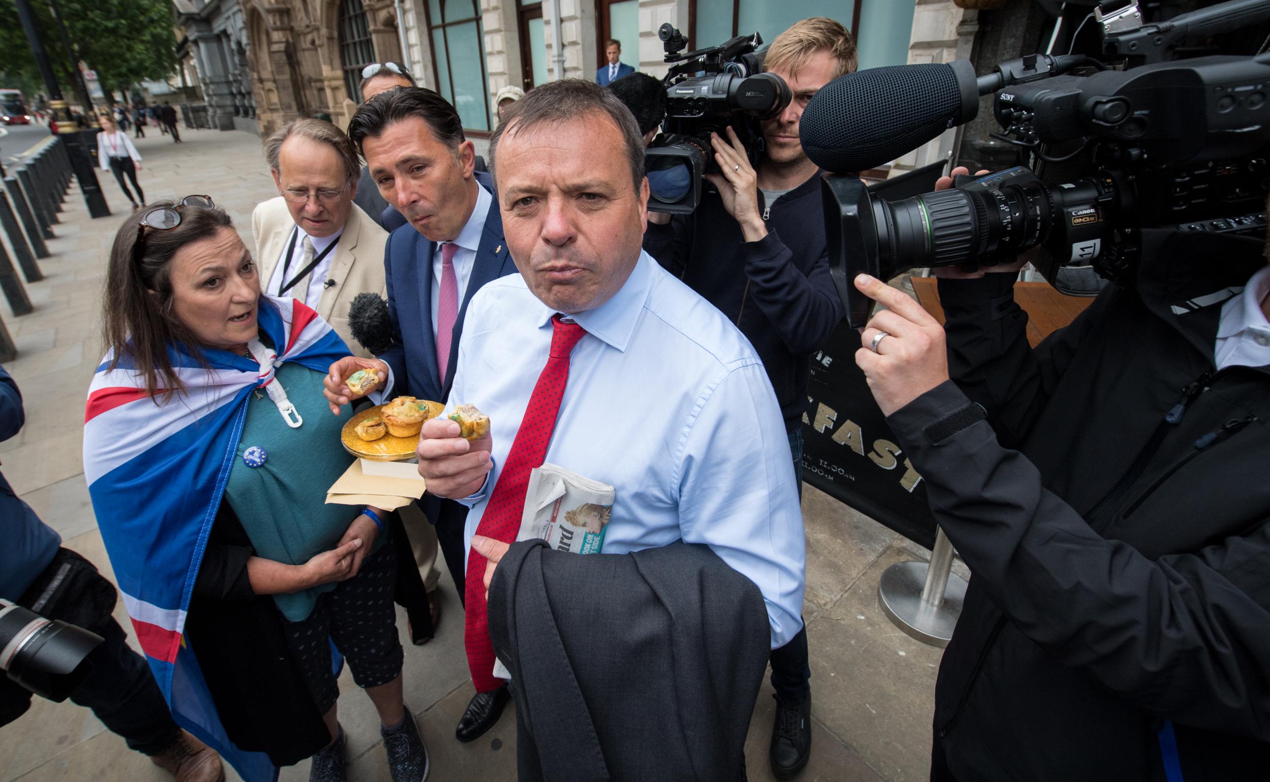 Leave.EU backer Arron Banks eats a pork pie after giving evidence to MPs in Westminster earlier this year