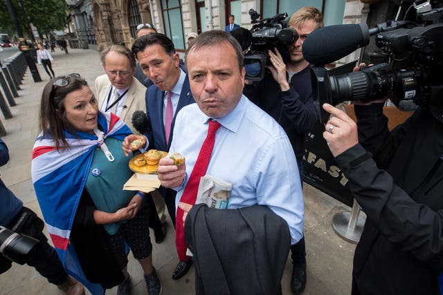 Leave.EU backer Arron Banks eats a pork pie after giving evidence to MPs in Westminster earlier this year