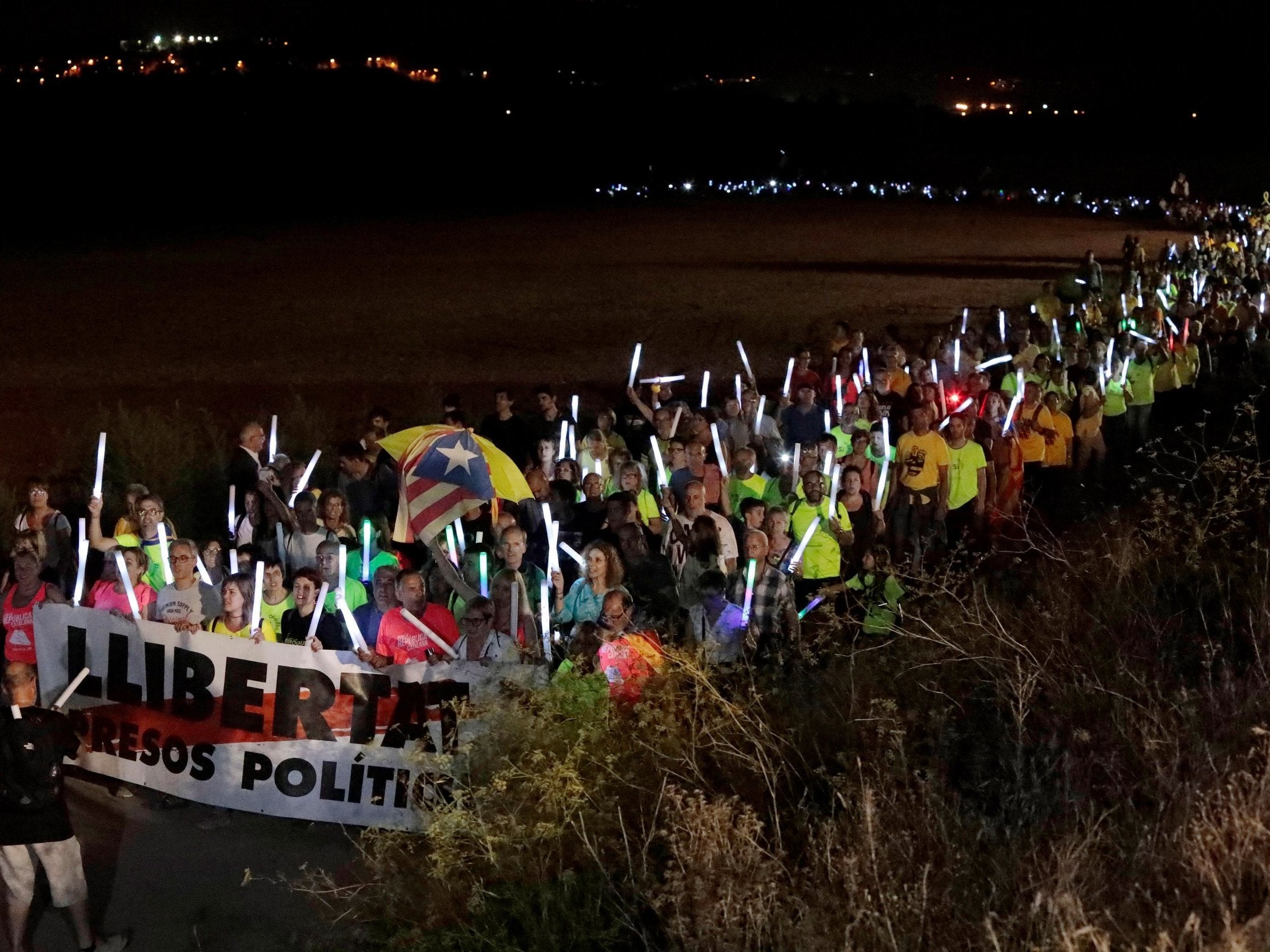 People attend a march called for by Catalan pro-independence group Asamblea Nacional Catalana to demand freedom for imprisoned Catalonian politicians the day before Diada