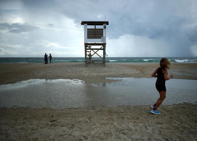 A jogger runs past a lifeguard stand as Hurricane Florence approaches in Wrightsville Beach
