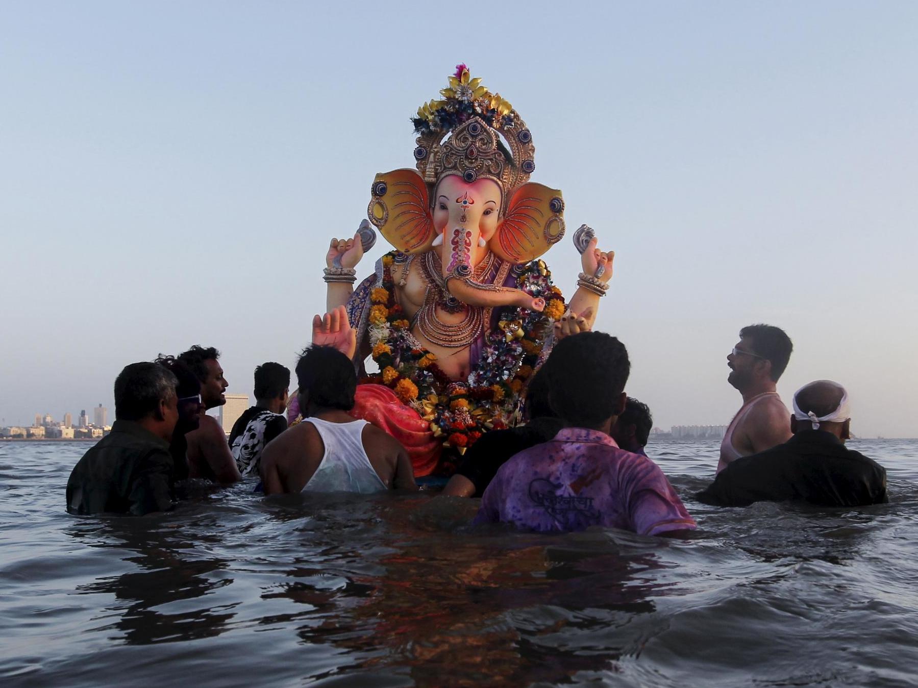 Devotees carry an idol of the Hindu elephant god Ganesha, the deity of prosperity, for immersion into the Arabian Sea on the last day of the Ganesh Chaturthi festival in Mumbai, India
