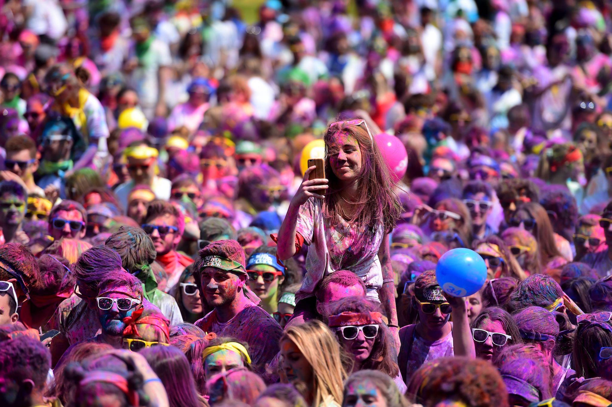 Runners attend a DJ concert after finishing the Burdi Colors race on May 5, 2018 in Pessac, southwestern France
